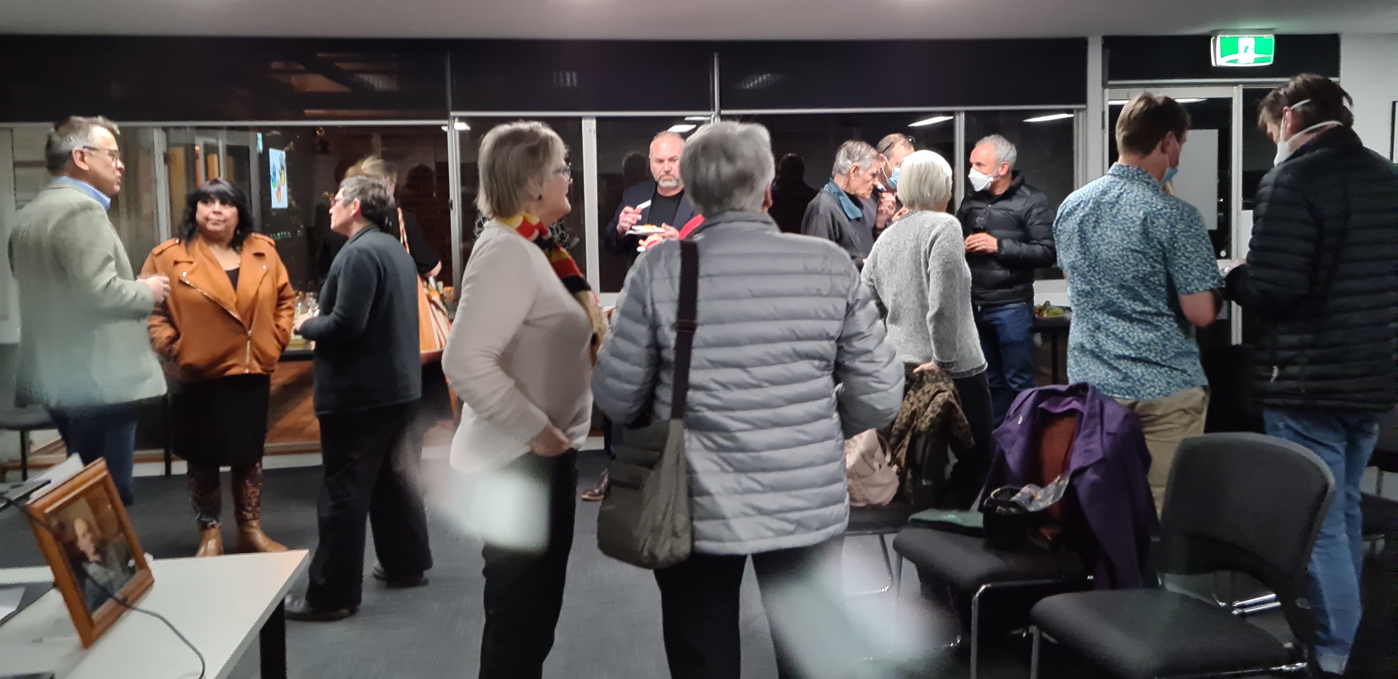 Gathering of people after lecture - Chris Bourke on left, Cheryl Axleby second left